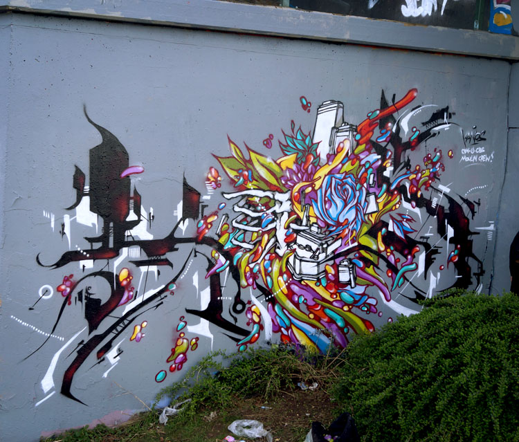 kanos is painting a wall in germany