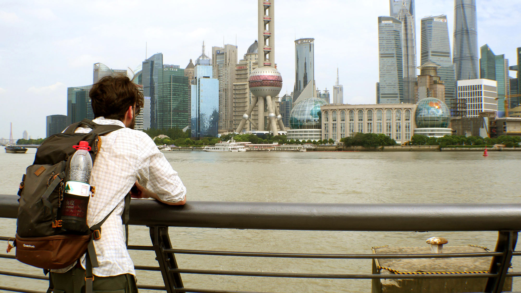 alex kanos is looking towards city of shanghai