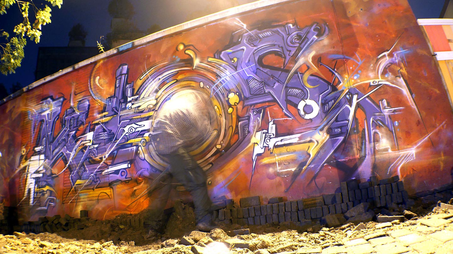 alex kanos is painting a wall at night in shanghai