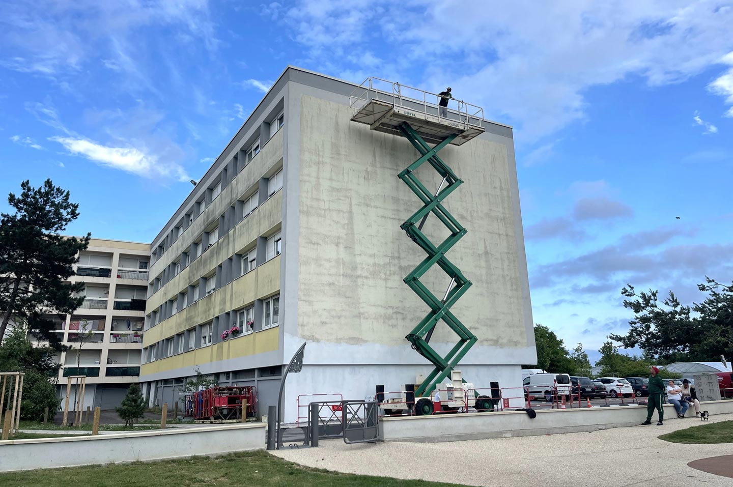 a mural street art in progress with alex kanos on a lift elevator in metz