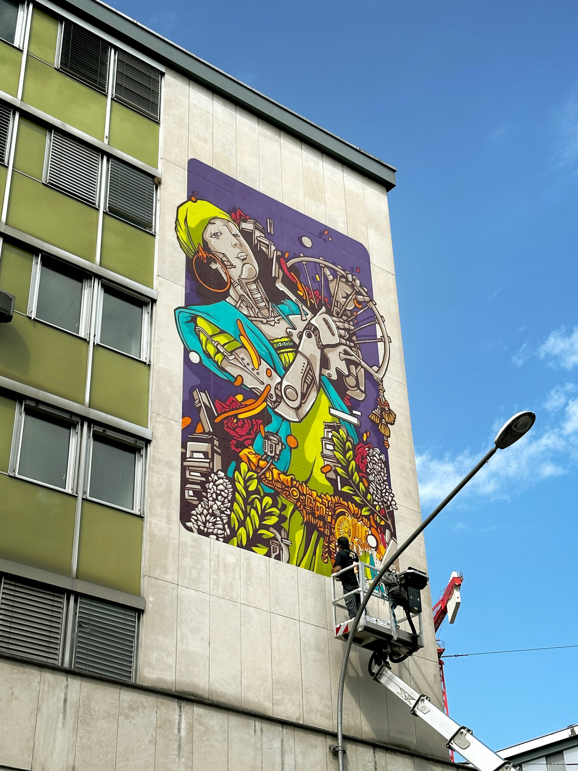 Alex Kanos is painting a mural in Geneva