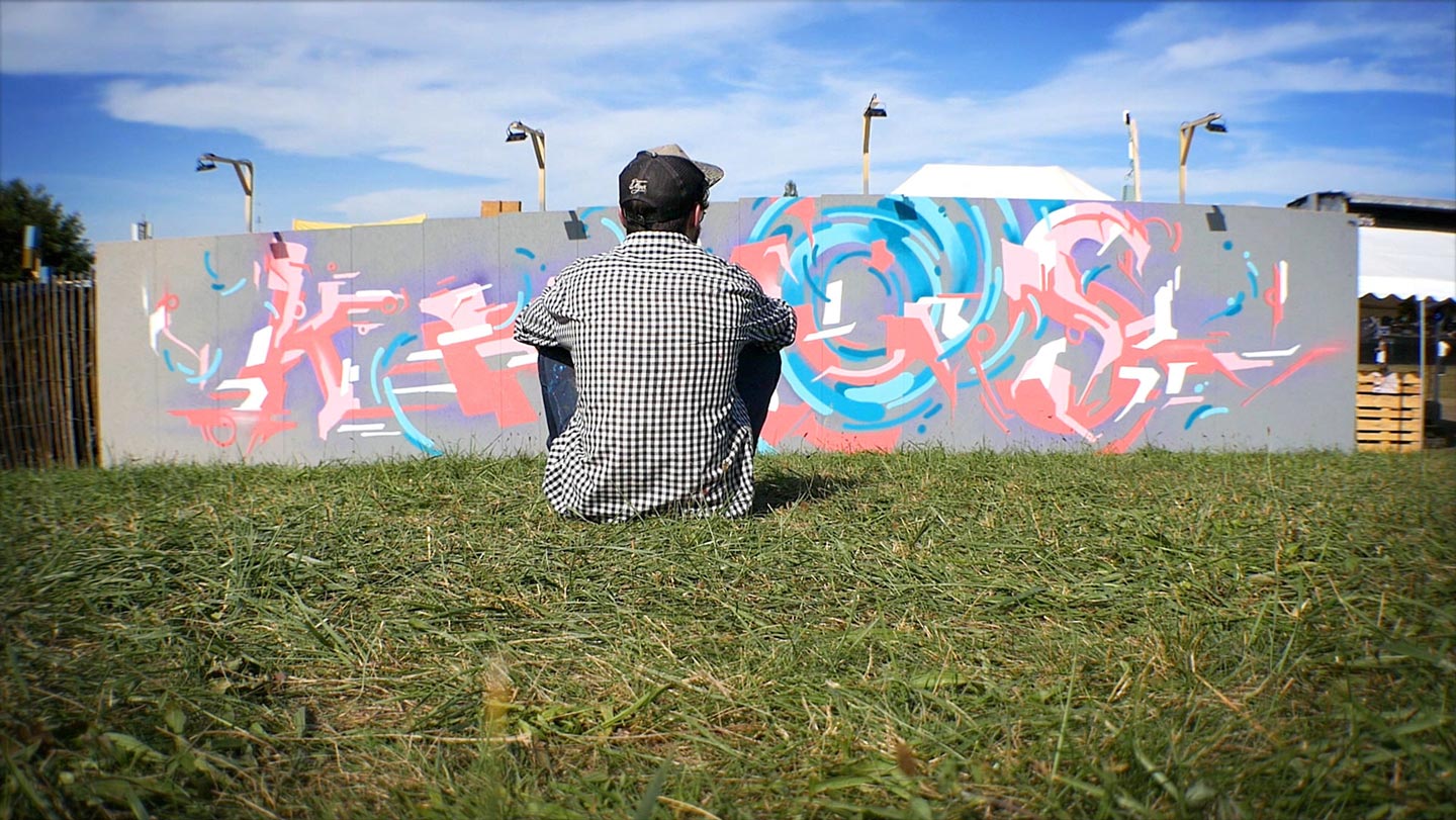 alex kanos is looking to his graffiti made during plein-les-watts festival in geneva