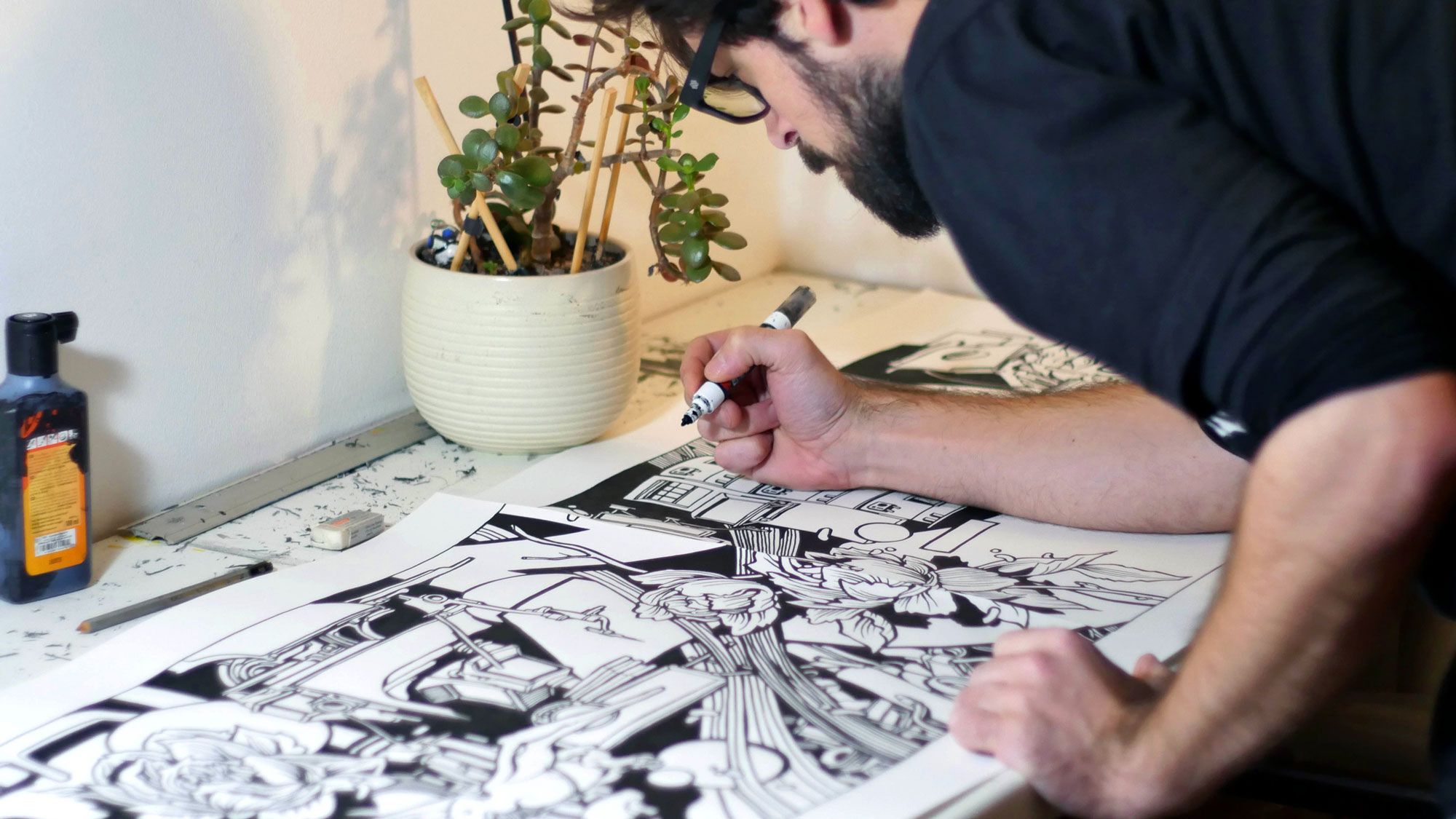 alex kanos is sketching on paper sheets